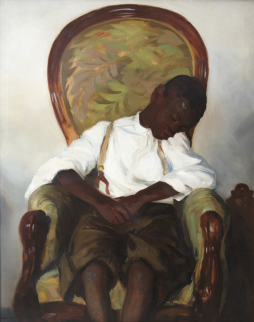 A painting of a Black boy dressed in shorts, suspenders, and a white collared shirt. He is sleeping in a wingback chair that has a green leaf pattern fabric.